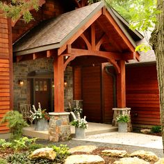 the front entrance to a home with stone and wood accents