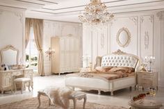 a bedroom with white furniture and chandelier