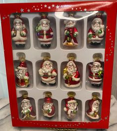 twelve glass christmas ornaments in a red box