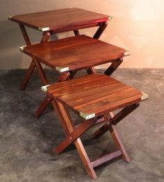 three wooden tables stacked on top of each other