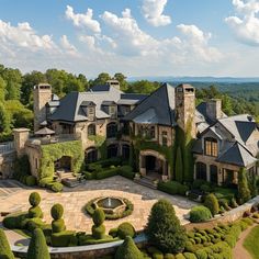 an aerial view of a large home surrounded by greenery