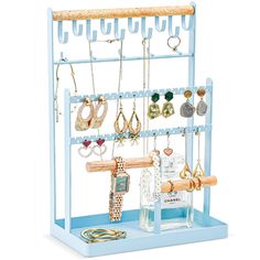 a blue jewelry rack with earrings and necklaces on it