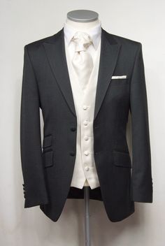 a tuxedo jacket on a mannequin with a white shirt and tie