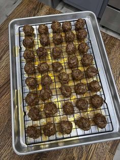 some meatballs are sitting on a baking sheet and ready to go into the oven