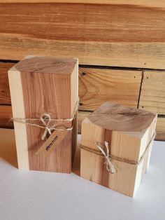 two wooden boxes tied with twine and sitting next to each other