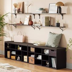 a living room filled with lots of furniture next to a wall mounted bookshelf