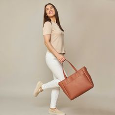 This structured tote is the ultimate do-it-all bag that you deserve. It's the perfect carryall for work, travel, and anywhere your day brings you. It features a spacious and organized interior for your essentials, a padded compartment for your laptop, side pockets for your drinks, and you can convert it into a backpack or crossbody. Crafted from premium American Saffiano leather that's waterproof and scratch-resistant, the Transform Tote will stay just as beautiful through all your travels and a Cognac Tote Travel Bag For Everyday Use, Cognac Travel Bag For Everyday Use, Chic Tote Laptop Bag For On-the-go, Everyday Cognac Tote Travel Bag, Workwear Tote Bag With Luggage Sleeve, Chic Bag With Luggage Sleeve For Work, Chic Workwear Bag With Luggage Sleeve, Modern Brown Weekender Bag For Everyday Use, Everyday Brown Leather Diaper Bag