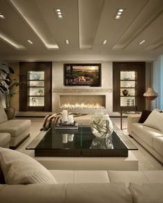 a living room filled with furniture and a fire place in the middle of the room