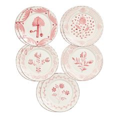 four pink and white plates with designs on them