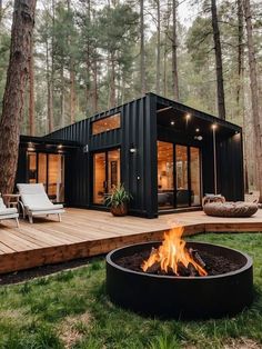 a small cabin in the woods with a fire pit