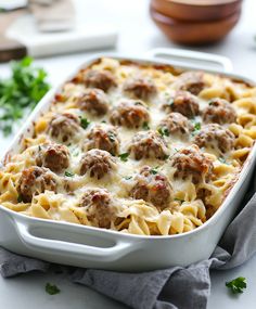 a casserole dish filled with meatballs and cheese