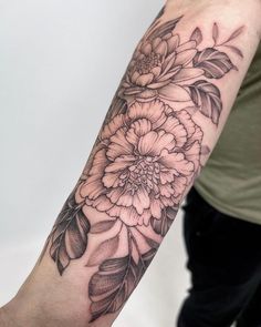 a person with a flower tattoo on their arm