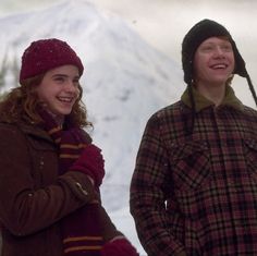 two people standing next to each other in the snow