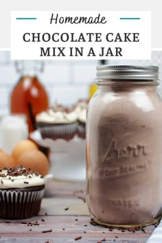 homemade chocolate cake mix in a jar with cupcakes and other ingredients around it