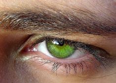 an eye with green eyeshade and brown hair