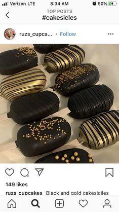 there are many black and gold cookies on the table