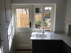 a kitchen with a sink and windows in it