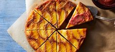 a sliced pineapple upside down cake sitting on top of a piece of parchment paper