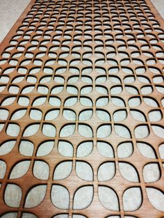 a close up of a wooden table with circles on it