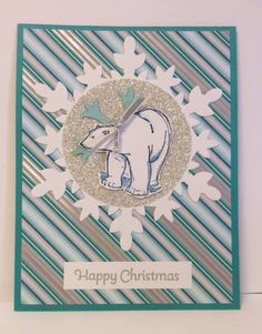 a handmade christmas card with an elephant and snowflakes on the bottom, which reads happy christmas