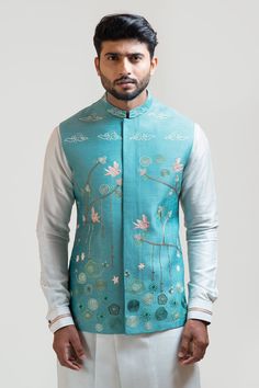 Blue Nehru jacket with madhubani motif embroidery using kantha stitch, aari, stitch work and french knots.
Component: 1
Embroidered
Neckline: Band
Sleeve Length: Sleeveless
Fabric: Bam Silk
Color: Blue
Side slit
Note: The kurta set worn by the model is not for sale - Aza Fashions Indian Wedding Suits Men, Male Design, Nehru Jacket For Men, Mens Indian Wear, Sleeveless Kurta, Indian Groom Wear, Gents Kurta Design, Motif Embroidery, Gents Kurta