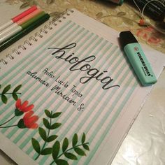 a notebook with writing on it next to markers and pens