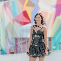 a woman in a batman corset posing for the camera with her hands on her hips