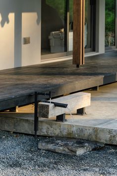 a water spout is coming out of the ground next to a concrete bench and steps