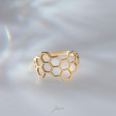 Shop our Original 925 Silver Honeycomb Engagement Ring on Etsy to add some buzz to your everyday look. This handmade ring features a unique hexagon shape band with a minimal bee comb design. It's the perfect accessory for any occasion, and makes a great gift for birthdays, Christmas, or for your best friend. Invest in your beauty and add this dainty hexagon shape band ring to your jewelry collection. Shop now and experience the love and care that goes into every piece. This dainty and elegant Stackable Ring would make the perfect family birthday gift or a treat for you! PRODUCT DETAILS The material is Solid 925 Sterling Silver. Gold and rose are plated over solid 925 sterling silver. ❤ The Ring comes in a special gift box All jewelers of LeianArt are hand-made. 🎁 All Your LeianArt jeweler Honeycomb Ring, Comb Design, Ring Hexagon, Pewter Ring, Hexagonal Ring, Fantasy Ring, Ring Minimal, Bridesmaid Rings, Thumb Rings Silver