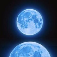 two blue moon shaped objects in the dark sky