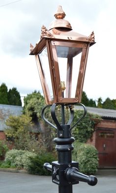 an old fashioned street light on a pole