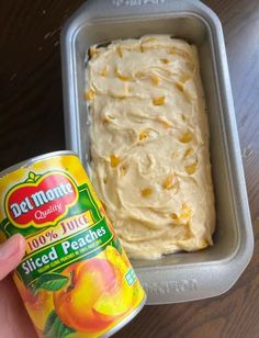 a person holding a can of peaches next to a container of sliced peaches