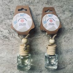 two small glass bottles with wooden stoppers attached to them