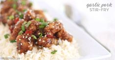 a white plate topped with rice and meat