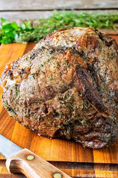 a large piece of meat sitting on top of a wooden cutting board