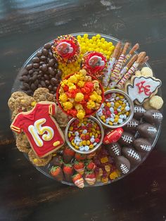 a football themed platter with cookies, candy and candies