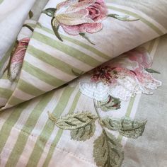 the fabric has flowers on it and is green and white striped material with pink stripes