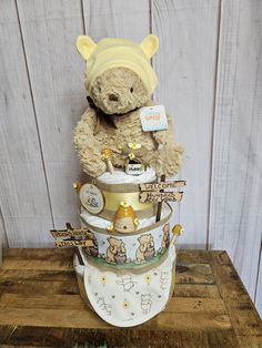 a teddy bear sitting on top of a stack of diapers