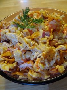 a bowl filled with food sitting on top of a wooden table