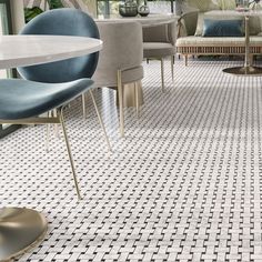 a living room filled with lots of furniture and decor on top of tiled flooring