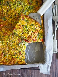 a casserole dish with vegetables and cheese on it, ready to be eaten