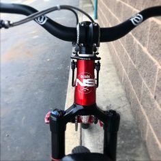 a close up view of the handle bars on a bike parked next to a brick wall