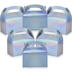 six boxes with holographic designs on them are arranged in the shape of a heart