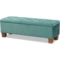 an upholstered bench with wooden legs and tufted seat cushion in teal