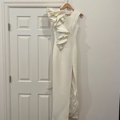 One Shoulder Ruffle Gown. Color Is Off White And A Bit More Pearl In Color. Zip Back. Perfect Condition. Worn 1 Time. White Ruffle Maxi Dress For Wedding Guest, Fitted Gown With Ruffles For Wedding Guest, Fitted Ruffle Gown For Wedding Guest, White Floor-length Evening Dress With Ruffles, Sleeveless White Gown With Ruffles, White Sleeveless Gown With Ruffles, Chic Ruffled Gown For Wedding Guest, Formal White Gown With Ruffles, White Ruffled Cocktail Evening Dress