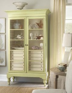 a living room with a green cabinet in the corner