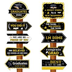 graduation signs on wooden posts with black and gold lettering, including congratulationss to graduates