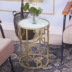 a vase with flowers on top of a glass table next to a basket and chair