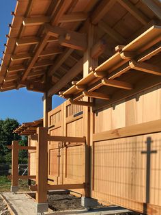 the side of a wooden building with an awning over it's entrance area