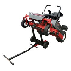 a red and black lawn mower sitting on top of a metal stand with wheels